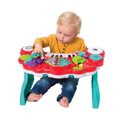 Child playing with an Infantino Bkids colorful toy piano on a white background