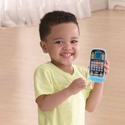 Child holding a Vtech toy phone with a smiling expression