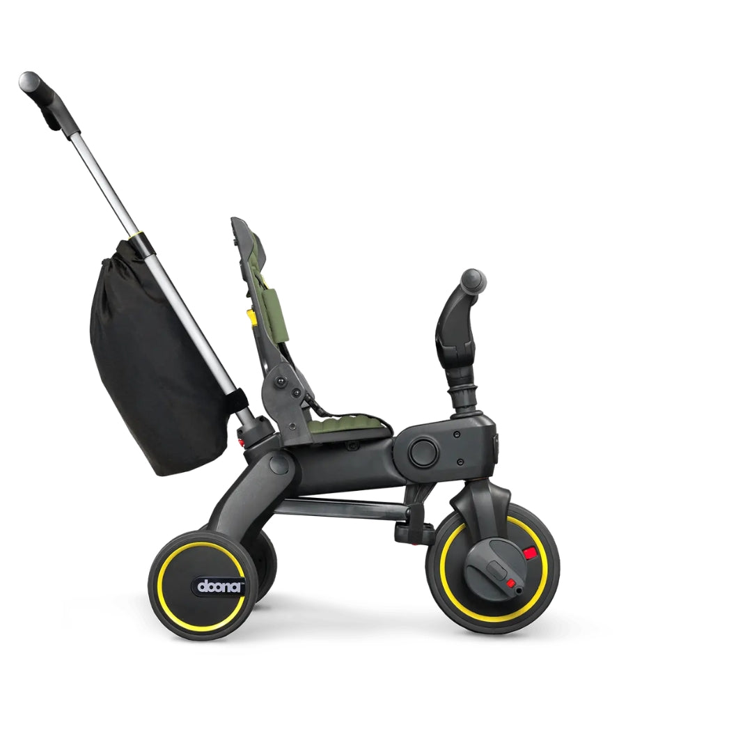 Doona Child's tricycle with black seat and yellow wheels on a white background