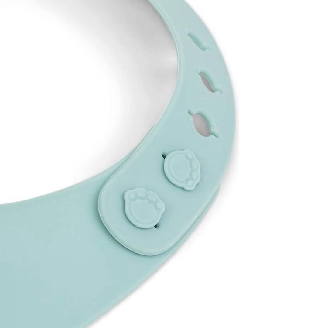 Light blue silicone bib with textured surface on a white background