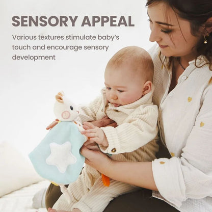 A mother holding her baby who is touching a blue star-patterned Sophie la Girafe comforter, with text reading 'Sensory Appeal: Various textures stimulate baby's touch and encourage sensory development.