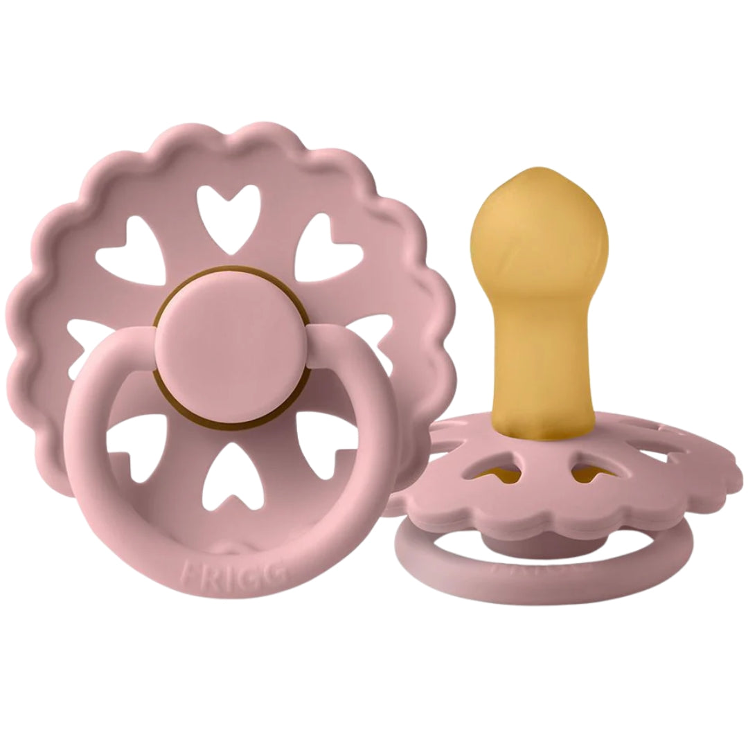 Frigg Pink baby pacifier with heart designs on a white background