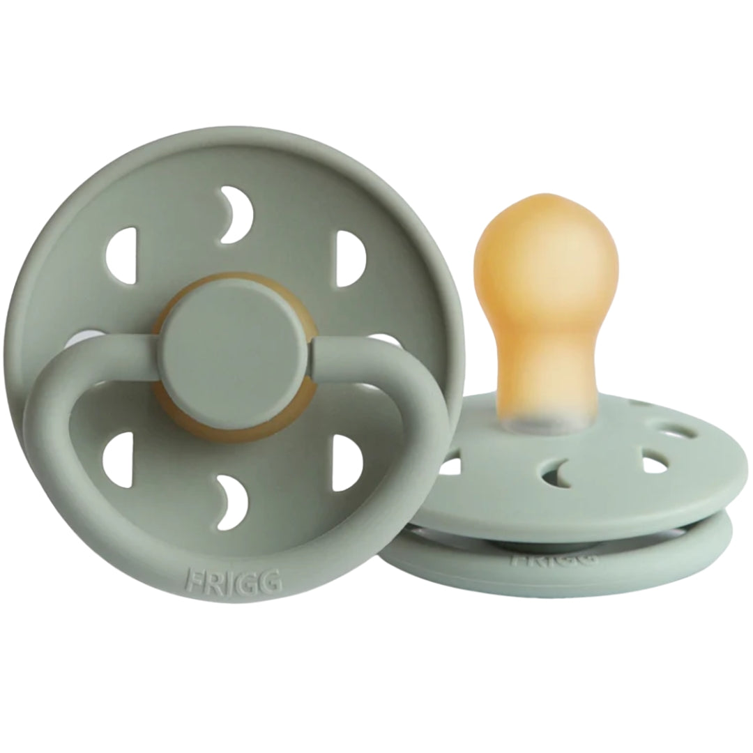 Frigg green baby pacifiers in a white background