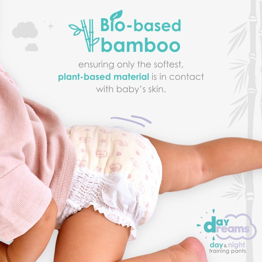 Child wearing a white diaper with 'daydreams' branding, emphasizing bio-based bamboo material.