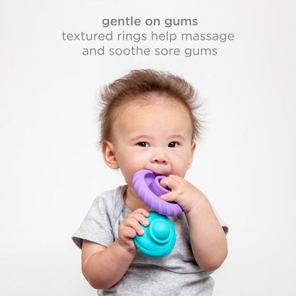 Baby holding a purple and blue teething ring with text about its benefits on a light gray background