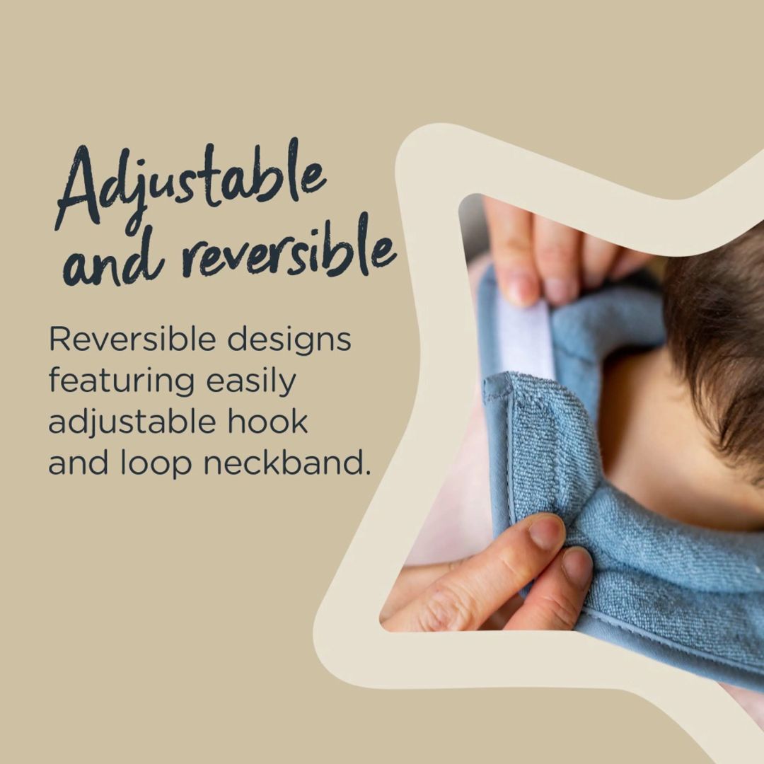 Baby wearing a blue reversible Tommee tippee Bib with text on a beige background