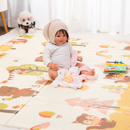 A baby playing on a Miila double sided playmat.