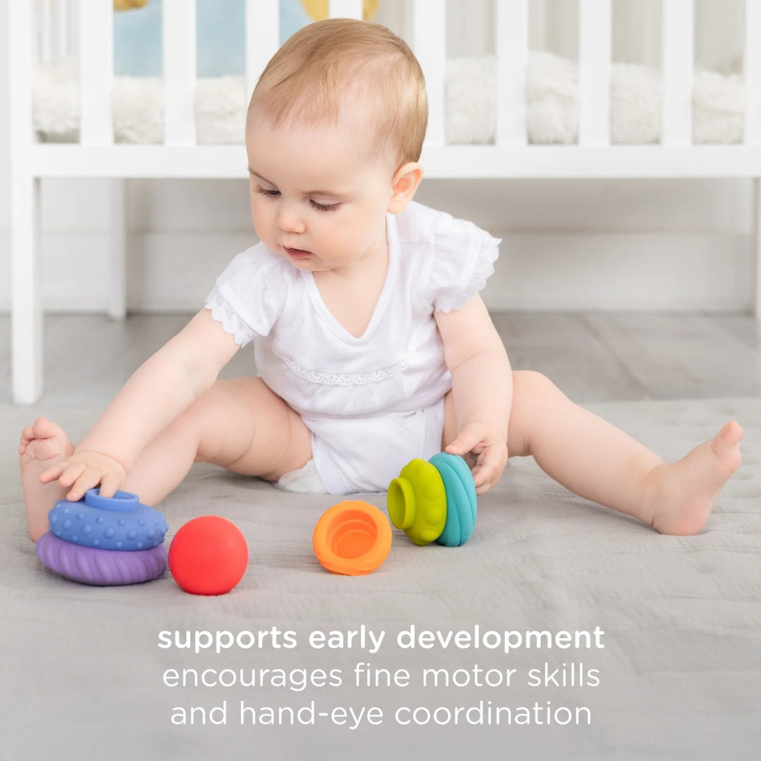 Baby playing with colorful toys on a bed, with text about early development and motor skills.