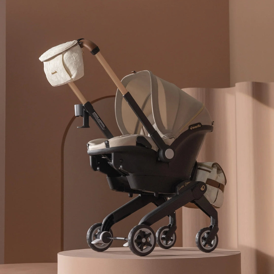 Evenflo Baby stroller with beige canopy on a brown background