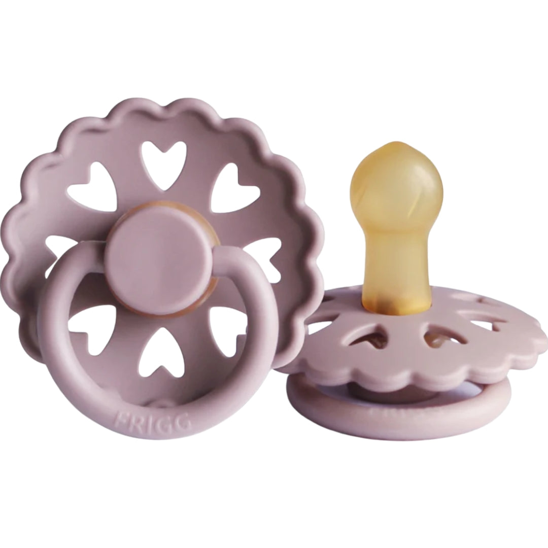 Frigg Pink baby teether with heart designs on a white background