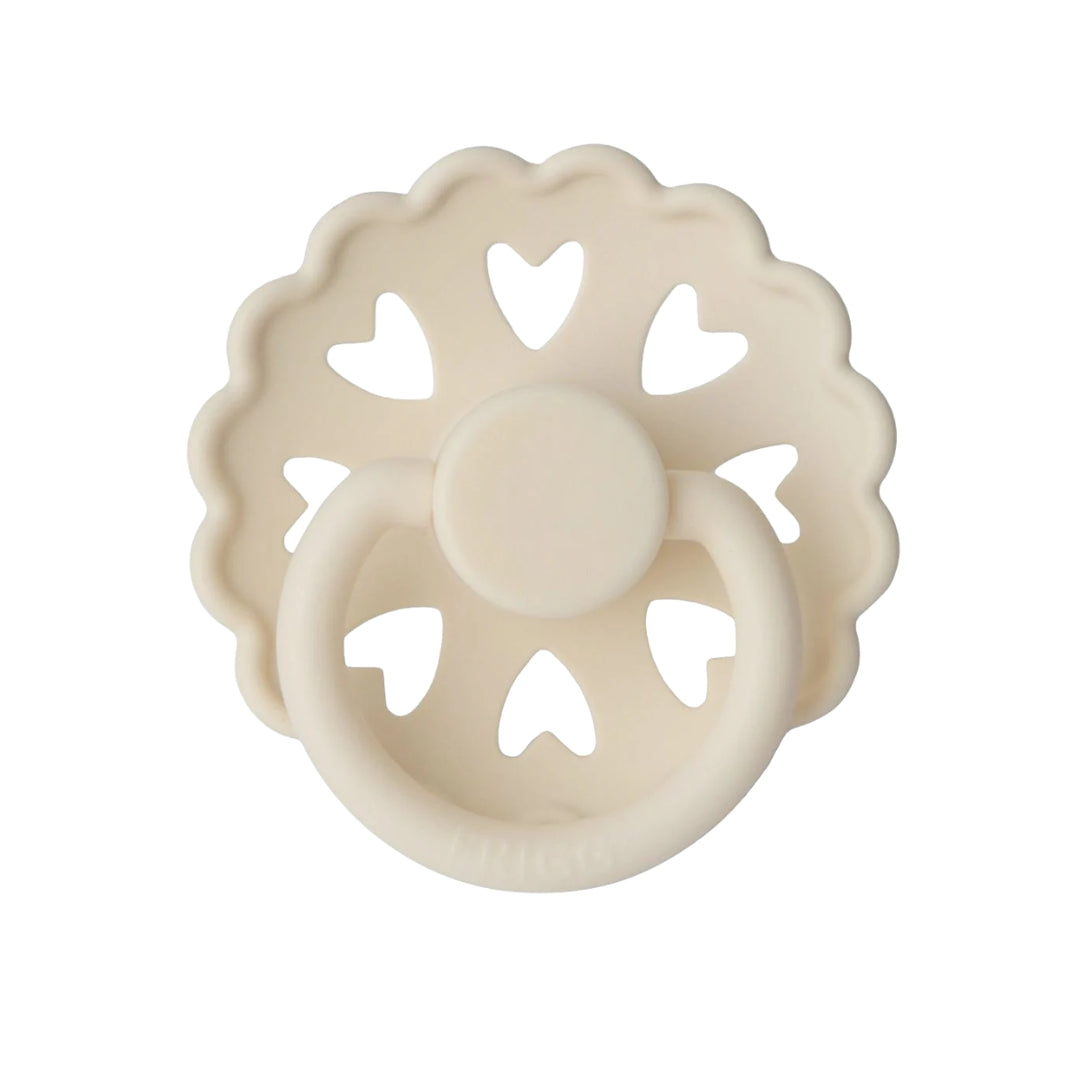 Frigg Beige teething ring with heart designs on a white background
