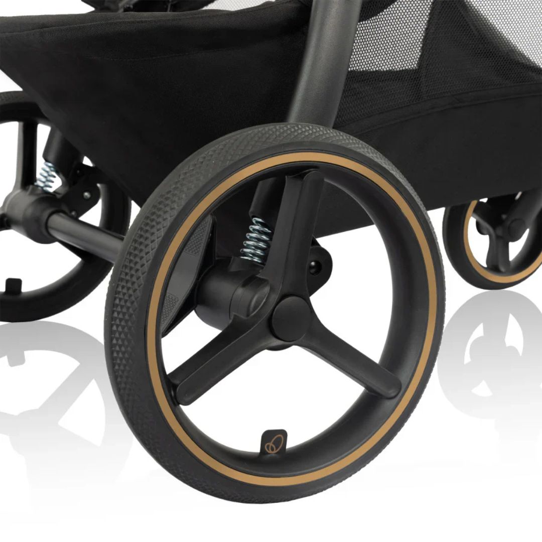 Evenflo Close-up of a stroller wheel with a reflective white background